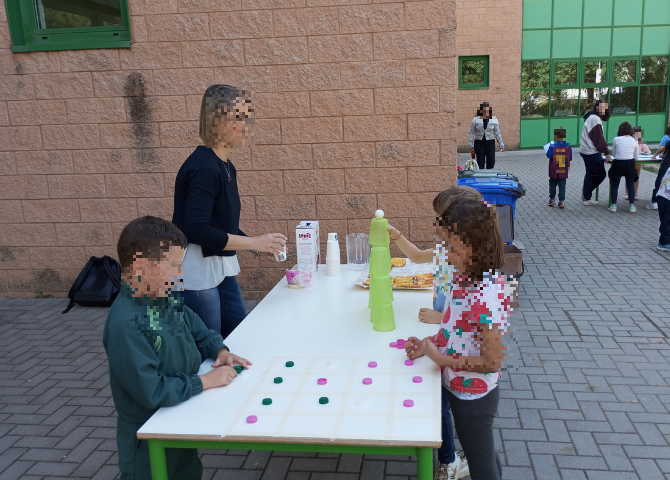 Foto con bambini che realizzano laboratorio attorno ad un tavolo